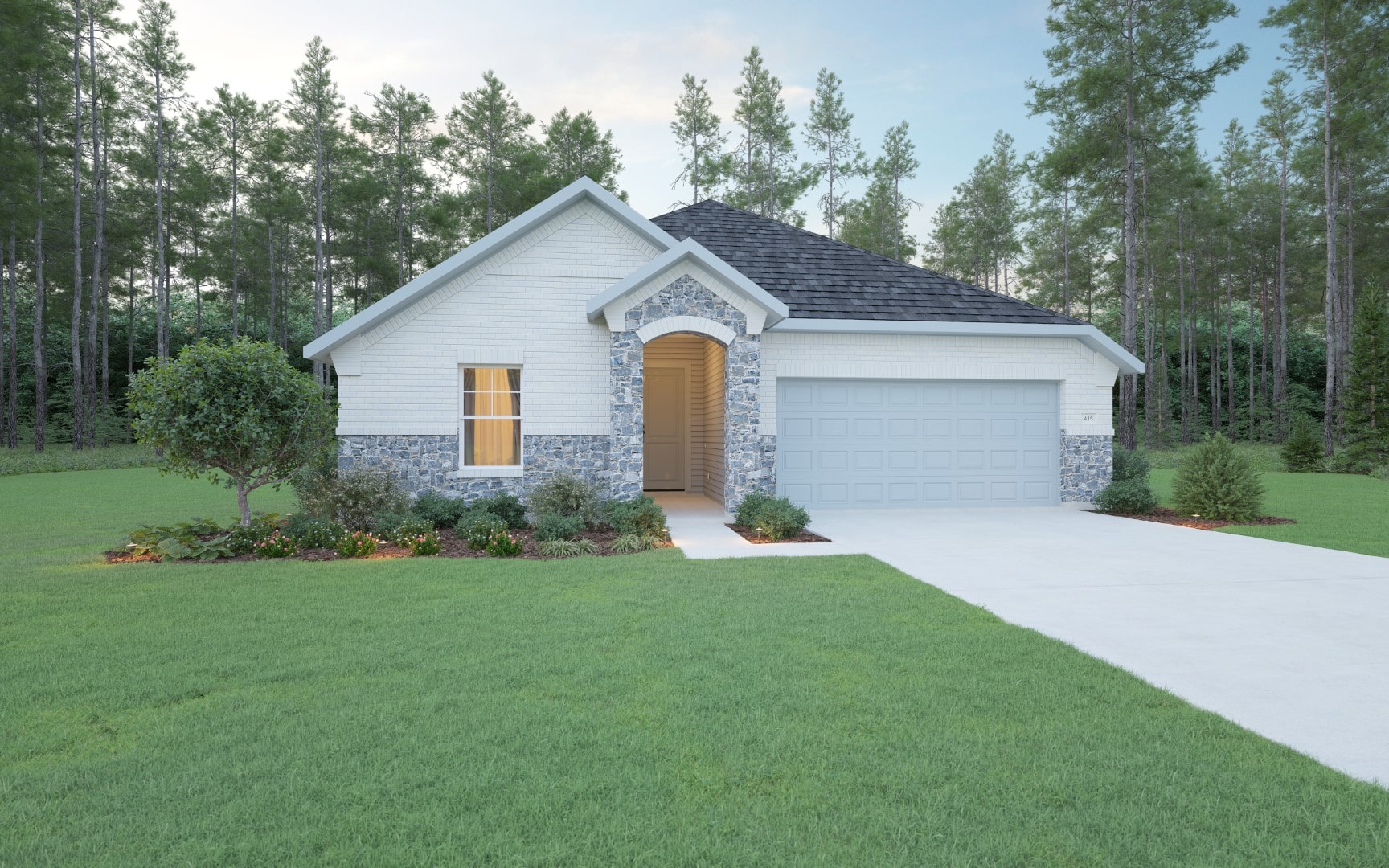 A single-story house with white and blue-gray brick exterior, gray shingle roof, and attached two-car garage. It is surrounded by green lawn, landscaped plants, and tall trees in the background.