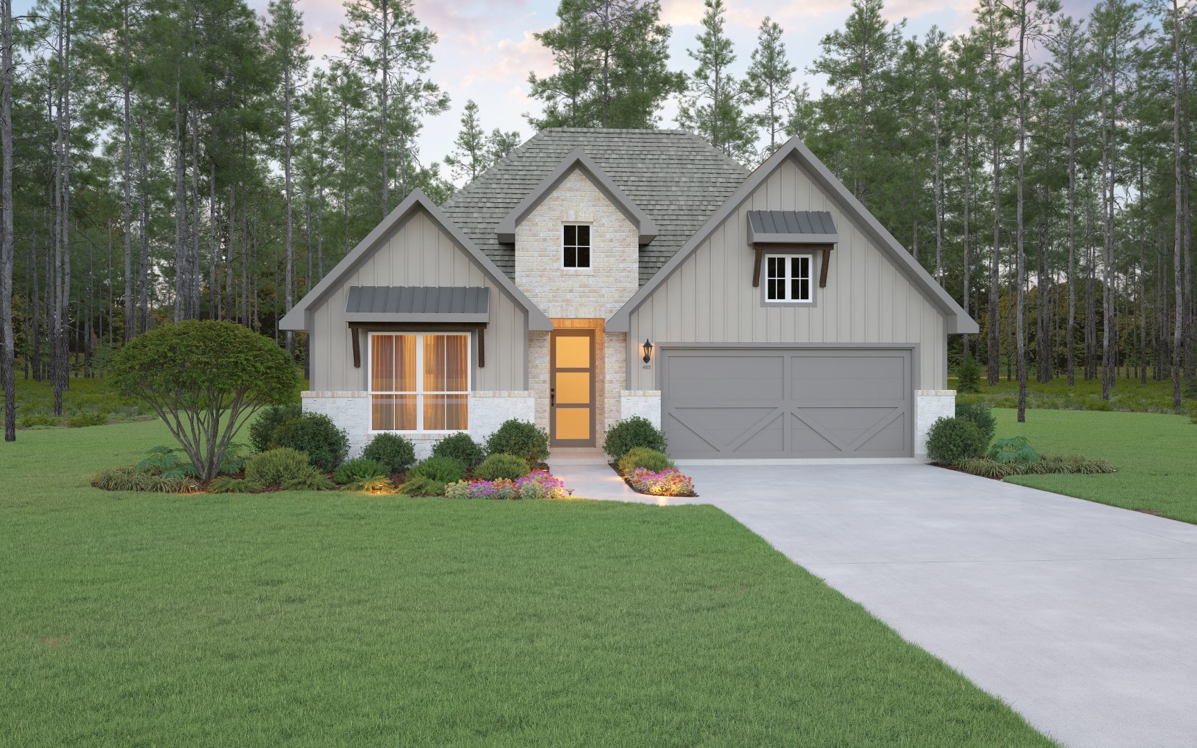 A modern house with a gray garage door, light-colored stone accents, and a manicured lawn, surrounded by shrubs, flowers, and tall trees in the background. The house is illuminated by warm exterior lights.