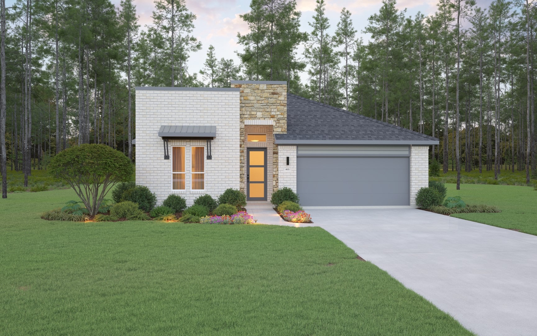 Modern single-story house with white brick and stone exterior, gray roof, double garage, front garden with shrubs and flowers, and a driveway, set against a backdrop of tall pine trees.