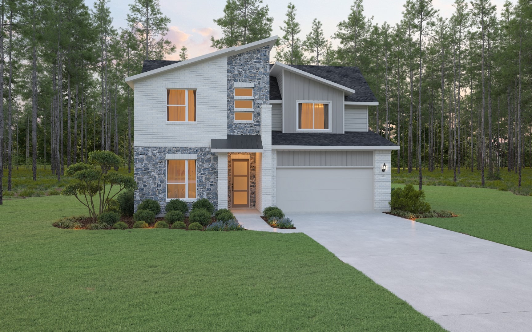 Two-story modern house with stone and white siding exterior, large windows, and a single-car garage. The home is surrounded by a green lawn, landscaped bushes, and trees, with a forest in the background.