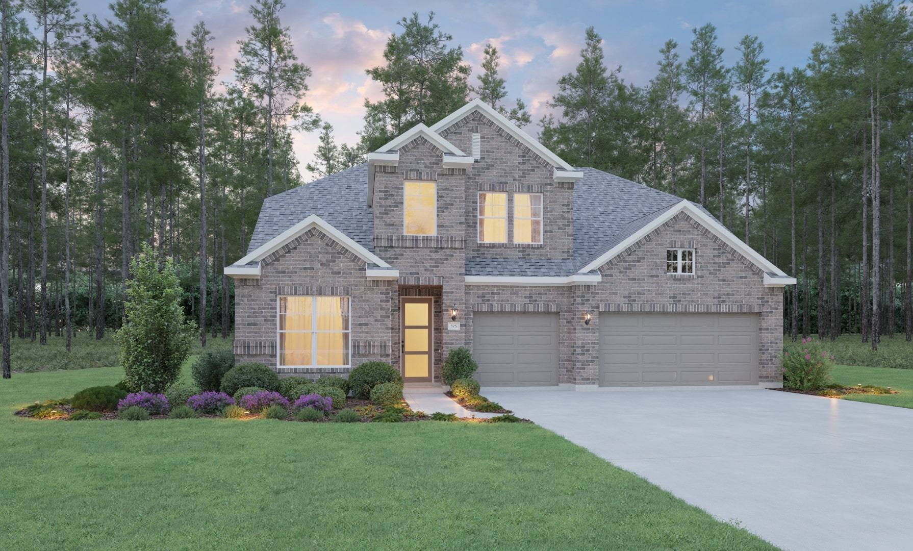 A two-story brick house with large windows, three-car garage, manicured lawn, and landscaped shrubs, set against a backdrop of tall pine trees and a sunset sky.