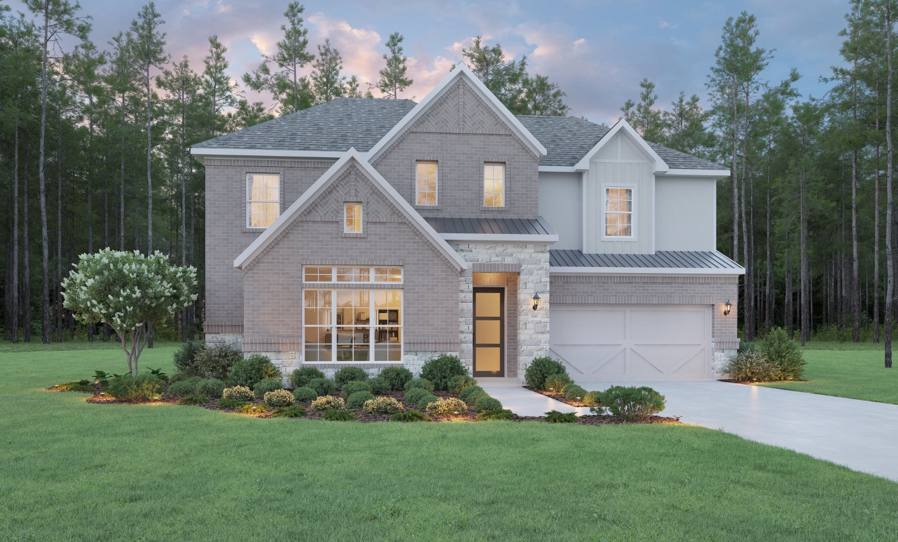 A modern two-story house with large windows, stone and brick exterior, a two-car garage, and a neatly landscaped front yard, surrounded by green grass and tall trees at dusk.