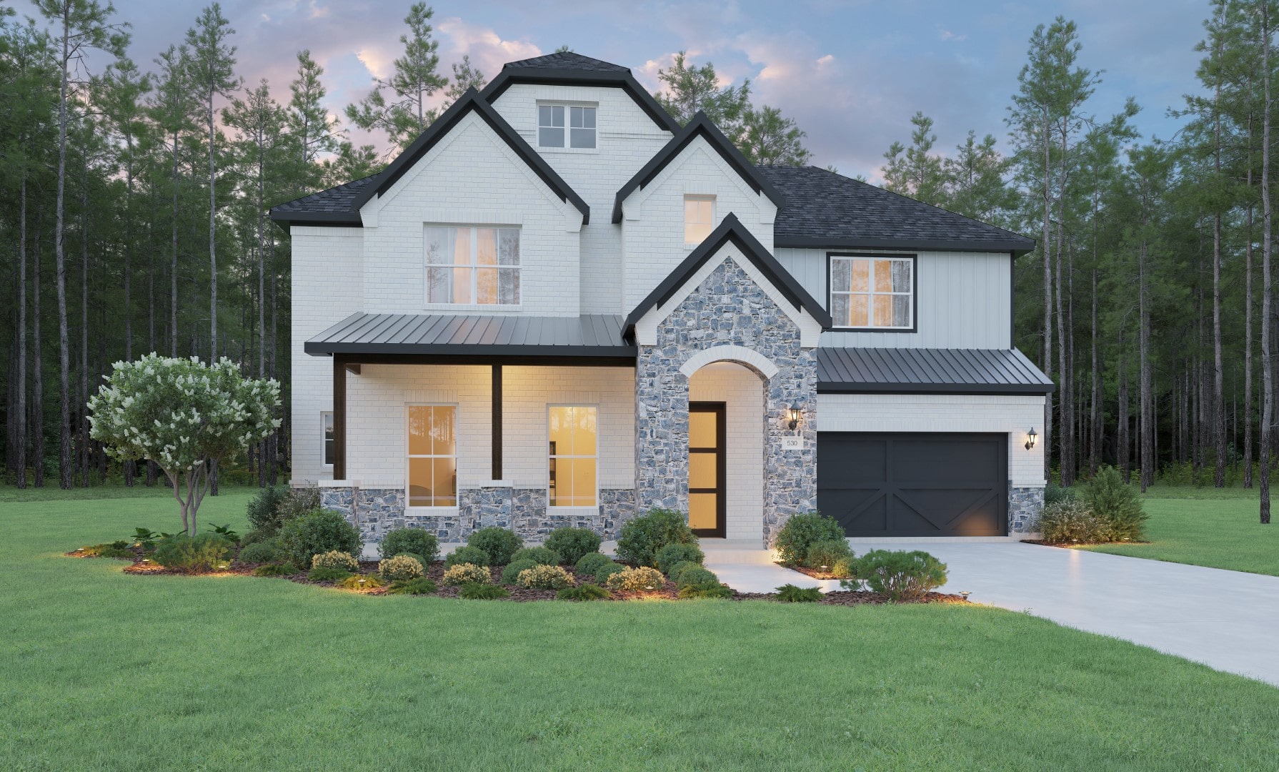 A modern two-story house with white brick and stone exterior, black roof, large windows, a black garage door, front porch, and a well-manicured lawn with shrubs and trees, set against a backdrop of tall pine trees.