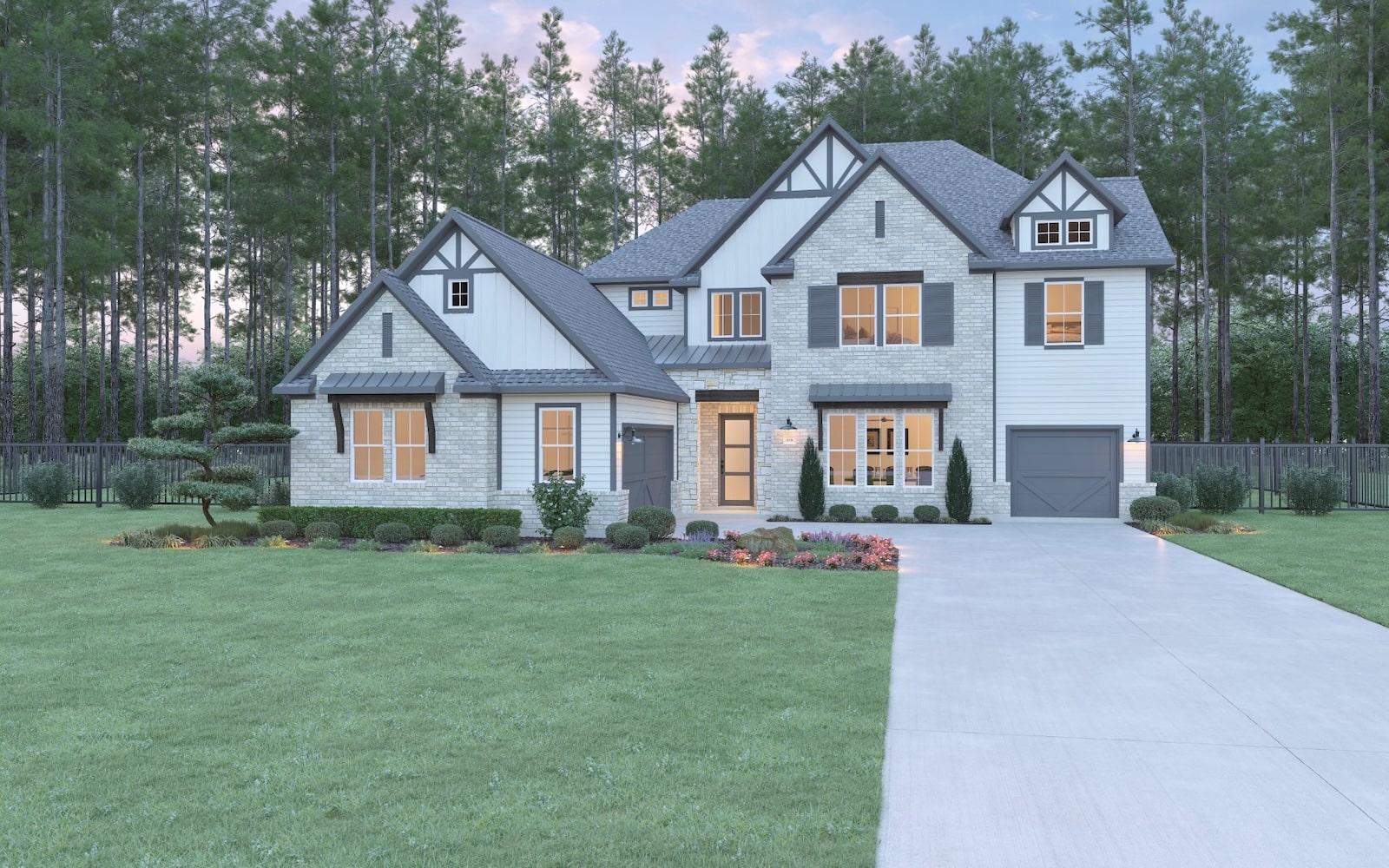 A large two-story suburban house with gray brick and siding, peaked roofs, and several windows lit from within. The house has landscaped bushes, green lawn, a driveway, and is surrounded by tall pine trees.